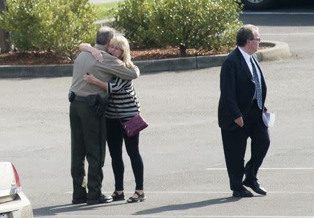 People hug as they arrive for the funeral service of Umpqua Community College student Jason Johnson in Roseburg, Oregon October 8, 2015. REUTERS/Amanda Loman