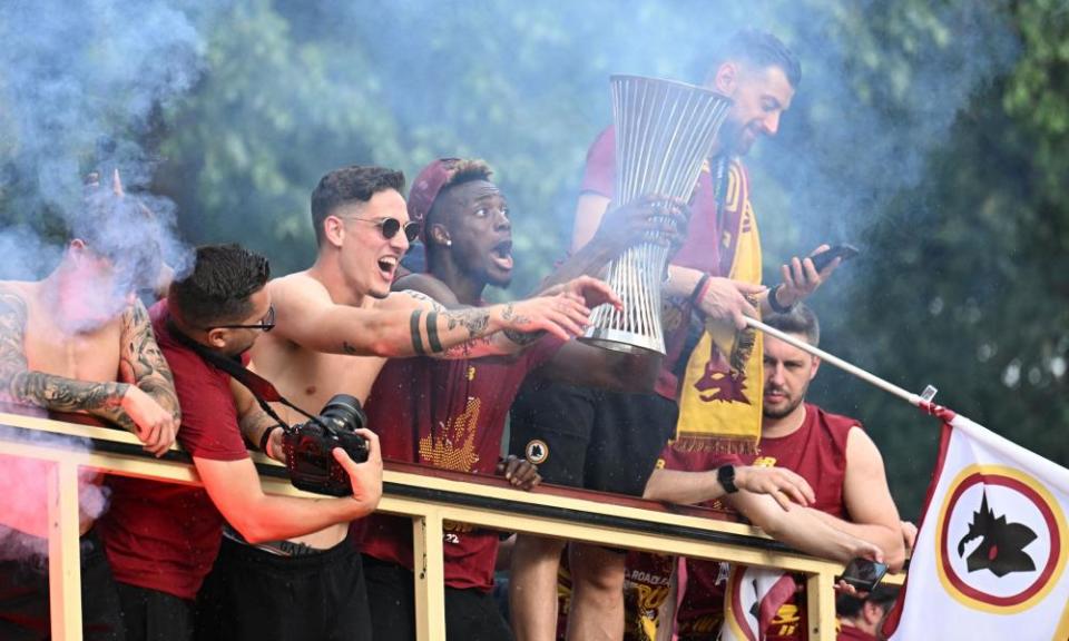 Roma’s Tammy Abraham celebrates on the bus with the Europa Conference League trophy.