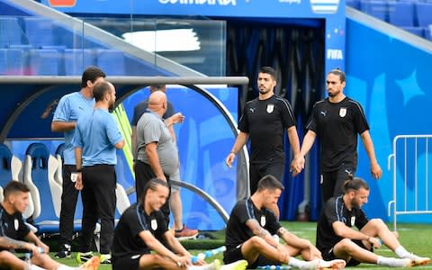 Uruguay's Luis Suarez and Uruguay's Martin Caceres arrive to Uruguay's official training on the eve of the group A match between Russia and Uruguay at the 2018 soccer World Cup at the Samara Arena in Samara, Russia, Sunday, June 24, 2018 - Credit: AP