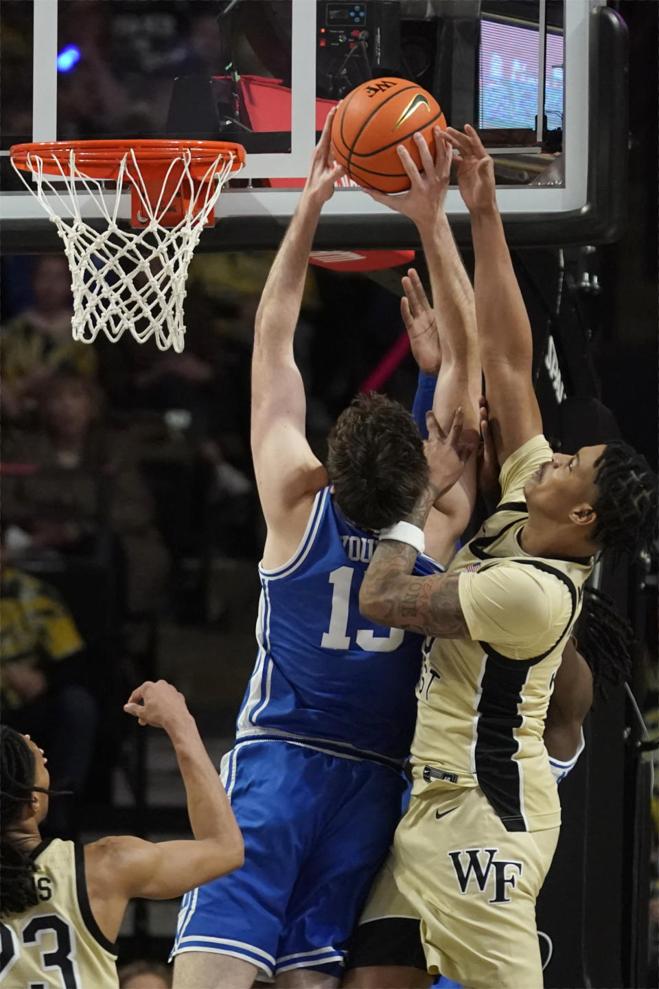 Wake Forest's Damari Monsanto, right, fouls Duke's Ryan Young, left, during the first half of an NCAA college basketball game in Winston-Salem, N.C., Saturday, Feb. 24, 2024. (AP Photo/Chuck Burton)