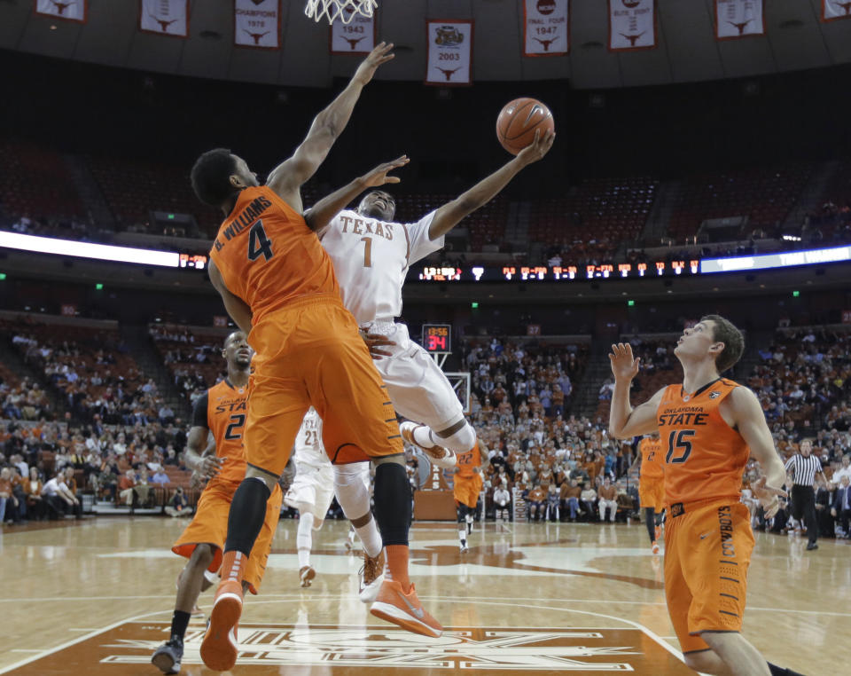 Texas' Isaiah Taylor (1) drives against Oklahoma State's Brian Williams (4) during the first half on an NCAA college basketball game, Tuesday, Feb. 11, 2014, in Austin, Texas. (AP Photo/Eric Gay)