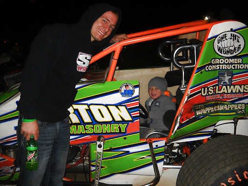 Josh Burton poses for a picture with a young fan in his sprint car. Courtesy photo