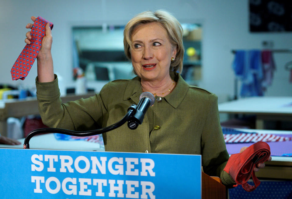 Hillary Clinton holds up a Donald Trump brand tie made in China