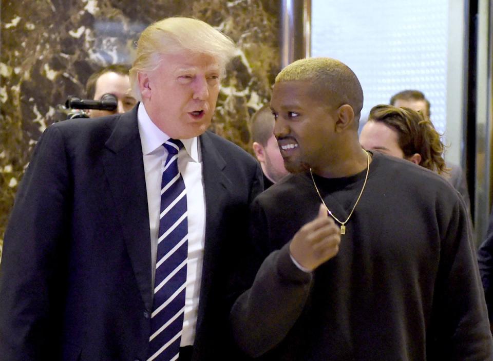 In this file photo taken on December 13, 2016, singer Kanye West and President-elect Donald Trump arrive to speak with the press after their meetings at Trump Tower in New York (AFP via Getty Images)
