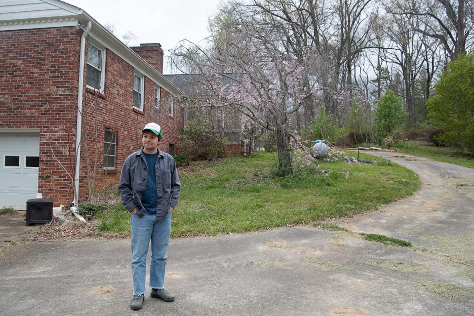 Colin Miller stands next to the home of his former landlord, Gary King, in Haw Creek, April 4, 2024.