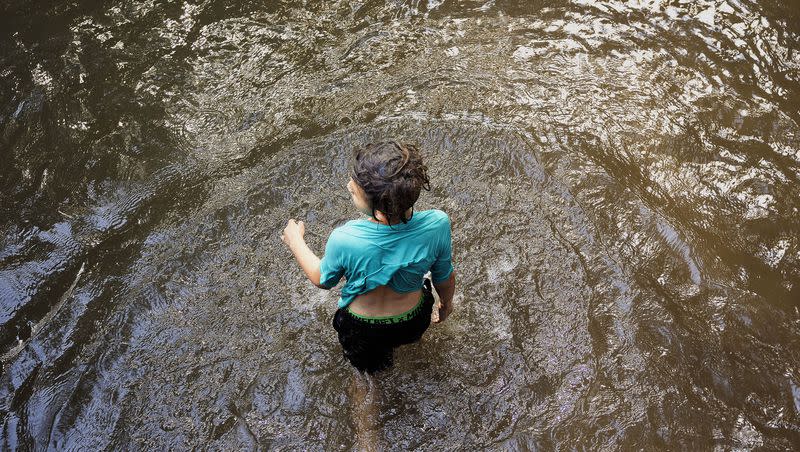 Oscar Ramirez, 8, walks in the creek in Sugar House Park in Salt Lake City on Friday, July 21, 2023. The temperature reached 100 on Friday, just the beginning of a predicted record-breaking heat wave. Temperatures have the possibility of reaching 105 degrees in Salt Lake City this weekend, experts say.