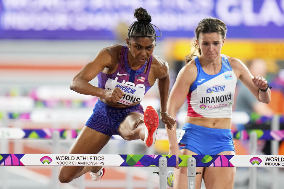 FILE - Christina Clemons, of the United States, and Helena Jiranova, of the Czech Republic, compete in a women's 60 meters hurdles heat during the World Athletics Indoor Championships at the Emirates Arena in Glasgow, Scotland, Sunday, March 3, 2024. U.S. Olympic hurdler Christina Clemons sent email after email raising concerns over a gap in health-care insurance coverage for new mothers who still wanted to compete. Those baby steps turned into big strides as USA Track and Field unveiled a program Thursday, April 25, that expands an existing maternity support system to give new moms even more time to return to an elite level. (AP Photo/Petr David Josek, File)