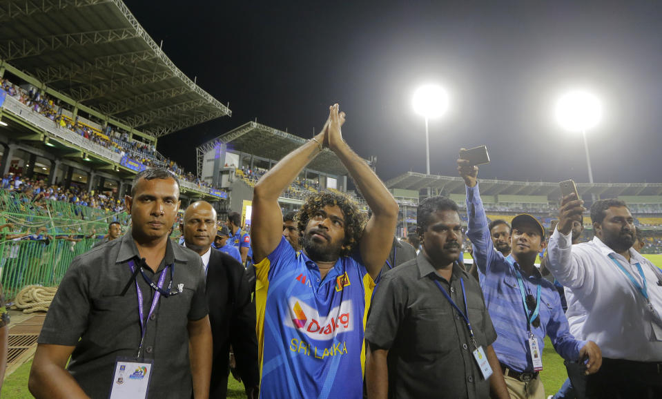 Sri Lanka's bowler Lasith Malinga who played his career last one-day international cricket match acknowledges the crowd after Sri Lanka defeated Bangladesh by 91 runs in the first one-day international cricket match between Sri Lanka and Bangladesh in Colombo, Sri Lanka, Friday, July 26, 2019. (AP Photo/Eranga Jayawardena)