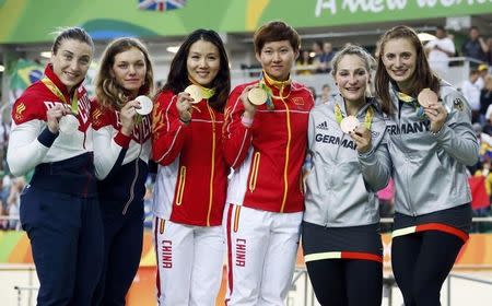 2016 Rio Olympics - Cycling Track - Victory ceremony - Women's Team Sprint Victory Ceremony - Rio Olympic Velodrome - Rio de Janeiro, Brazil - 12/08/2016. Daria Shmeleva (RUS) of Russia, Anastasiia Voinova (RUS) of Russia, Gong Jinjie (CHN) of China, Zhong Tianshi (CHN) of China, Kristina Vogel (GER) of Germany and Miriam Welte (GER) of Germany pose with their medals. REUTERS/Eric Gaillard