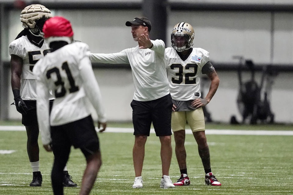 New Orleans Saints cornerback Tyrann Mathieu (32) runs through drills while head coach Dennis Allen gives instruction during training camp at the team's NFL football training facility in Metairie, La., Wednesday, Aug. 3, 2022. (AP Photo/Gerald Herbert)