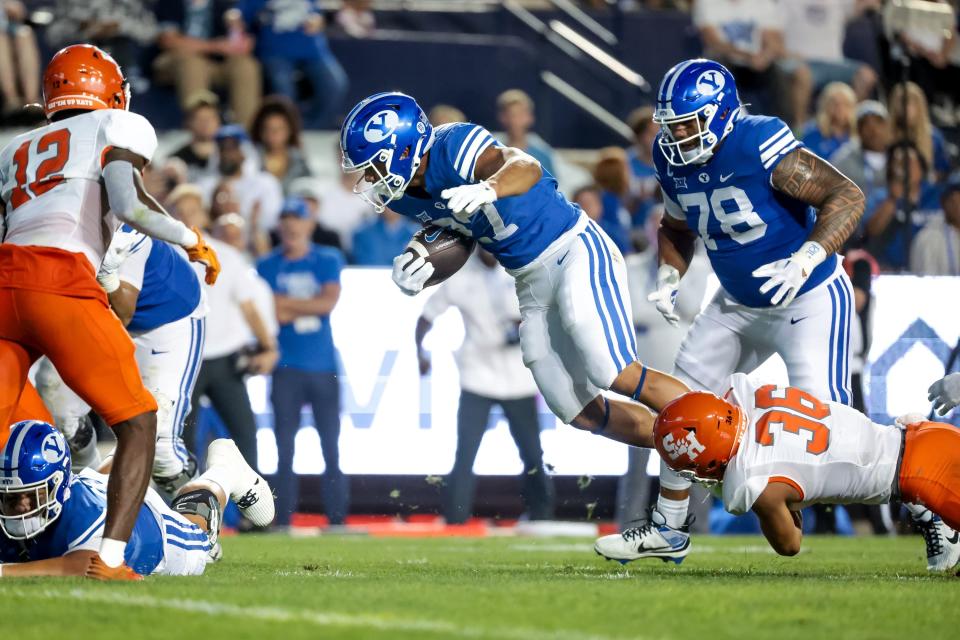 BYU Cougars running back LJ Martin (27) is tackled by Sam Houston Bearkats defensive back Elias Escobar (36) during the game at LaVell Edwards Stadium in Provo on Saturday, Sept. 2, 2023. | Spenser Heaps, Deseret News