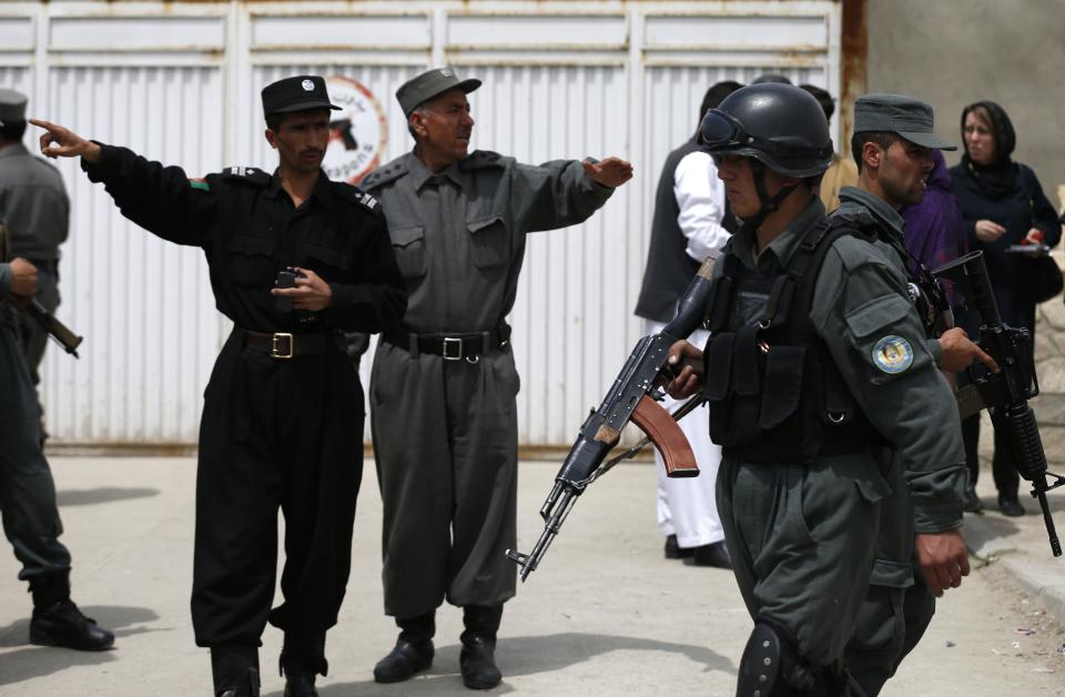 Afghan policemen stand outside Cure Hospital after three foreigners were killed in Kabul April 24, 2014. Three foreigners were killed on Thursday when a security guard opened fire at Cure Hospital, an international hospital, in the Afghan capital,�Kabul, security sources said, in the latest of a series of attacks against foreign civilians. REUTERS/Mohammad Ismail (AFGHANISTAN - Tags: CIVIL UNREST HEALTH)