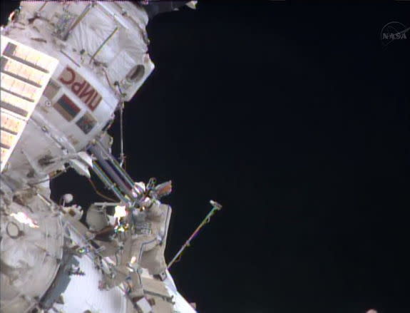 Expedition 35 flight engineers Pavel Vinogradov and Roman Romanenko (floating at lower left) worked outside the International Space Station on April 19, 2013.