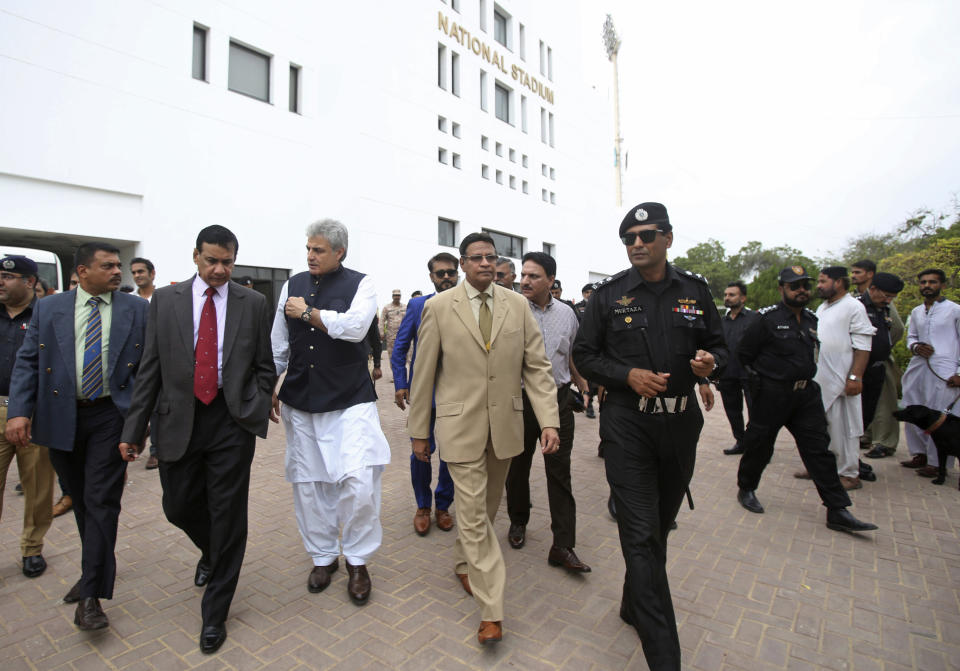 Honorary Secretary General of the Sri Lankan Cricket Board Mohan De Silva, center, visits National Stadium with Pakistani officials to review security assessments in Karachi, Pakistan, Wednesday, Aug. 7, 2019. The delegation will present a report and on the basis the Sri Lankan Cricket Board will decide whether their test team will visit Pakistan in October. (AP Photo/Fareed Khan)