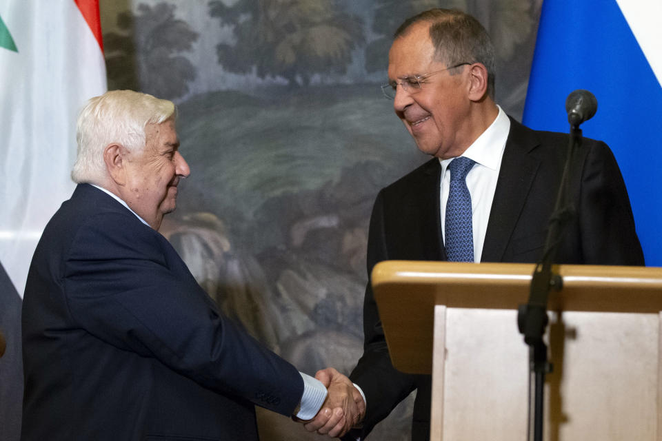 Russian Foreign Minister Sergey Lavrov, right, shakes hands with Syrian Foreign Minister Walid Muallem after their joint news conference followed talks in Moscow, Russia, Thursday, Aug. 30, 2018. Muallem's visit comes as Moscow and Damascus are increasingly worried about a possible airstrike on government positions in Syria. (AP Photo/Alexander Zemlianichenko)