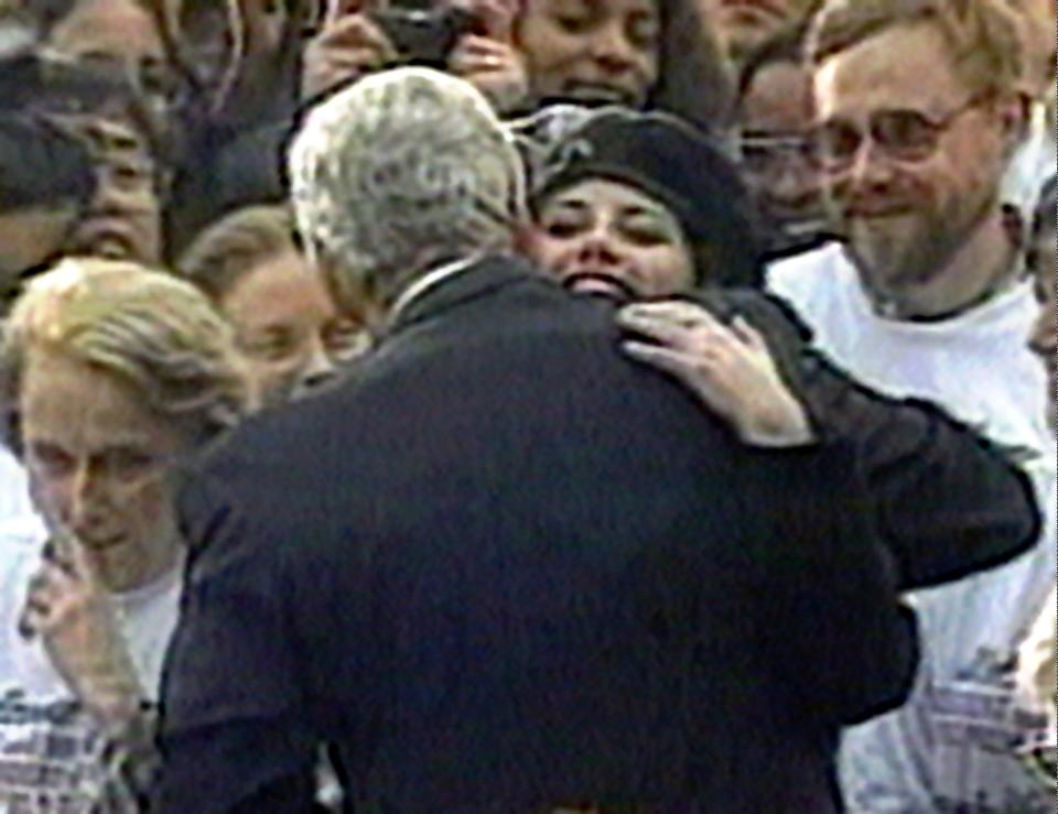 Monica Lewinsky embraces President Clinton as he greets well-wishers at a White House lawn party in Washington on Nov. 6, 1996.