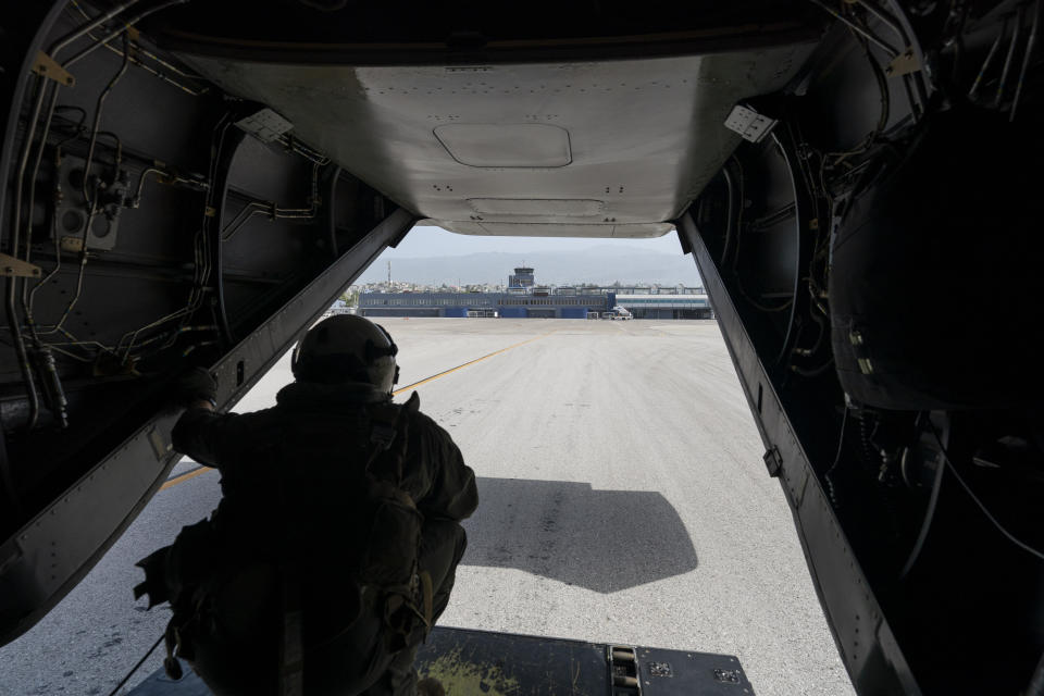 U.S. Marine Cpl. Thalles Souza, watches as a VM-22 Osprey, loaded with relief aid, taxis for departure at Toussaint Louverture International Airport, Saturday, Aug. 28, 2021, in Port-au-Prince, Haiti. The VMM-266, "Fighting Griffins," from Marine Corps Air Station New River, from Jacksonville, N.C., are flying in support of Joint Task Force Haiti after a 7.2 magnitude earthquake on Aug. 22, caused heavy damage to the country. (AP Photo/Alex Brandon)