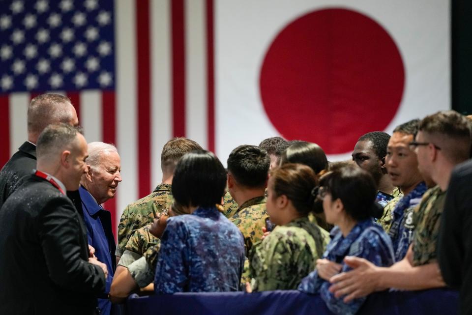 President Joe Biden, third left, greets troops upon his arrival at Marine Corps Air Station Iwakuni in Iwakuni, Japan, Thursday, May 18, 2023.