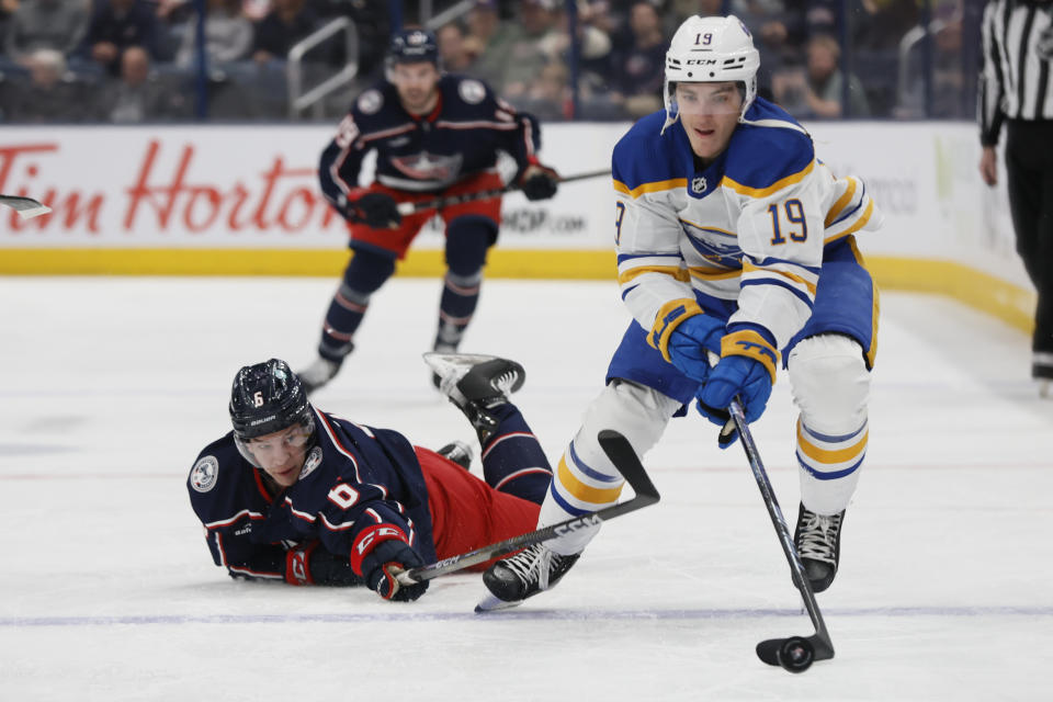 Buffalo Sabres' Peyton Krebs, right, carries the puck across the blue line as Columbus Blue Jackets' Billy Sweezey defends during the first period of an NHL hockey game Friday, April 14, 2023, in Columbus, Ohio. (AP Photo/Jay LaPrete)