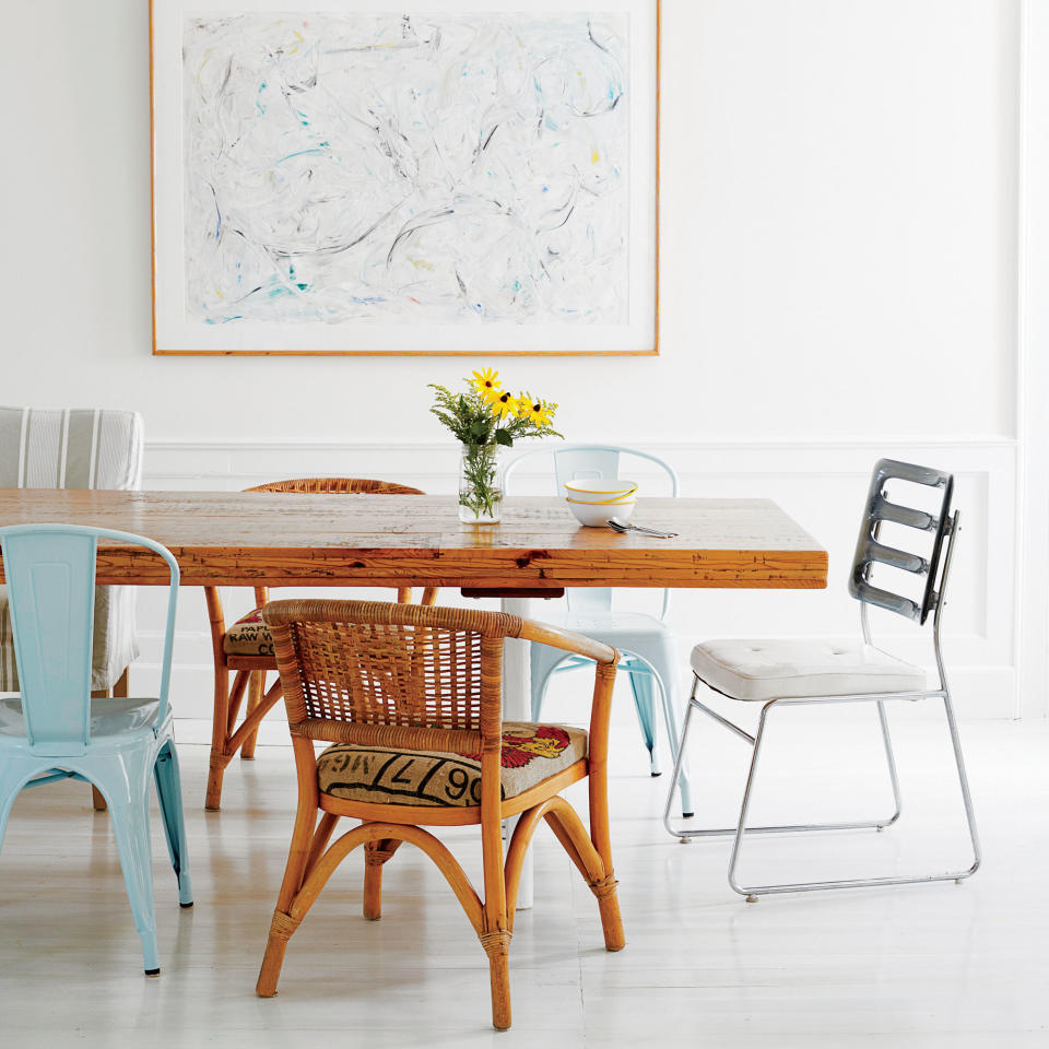 <p>Crisp white walls and light floors create a clean backdrop that nicely contrasts the warm wooden table and a band of chairs in varying materials and colors.</p> <p><strong>Idea Spotlight</strong></p> <p>Don’t be afraid to mix and match. A collection of mismatched chairs and benches (enough to seat 22!) in this dining room makes for a come one, come all atmosphere.</p>