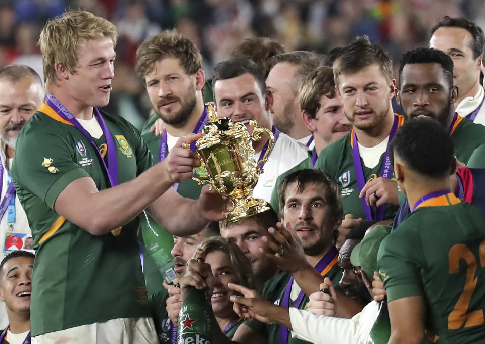 South Africa's Pieter-Steph du Toit holds the Webb Ellis Cup after South Africa defeated England to win the Rugby World Cup final at International Yokohama Stadium in Yokohama, Japan, Saturday, Nov. 2, 2019. (AP Photo/Eugene Hoshiko)