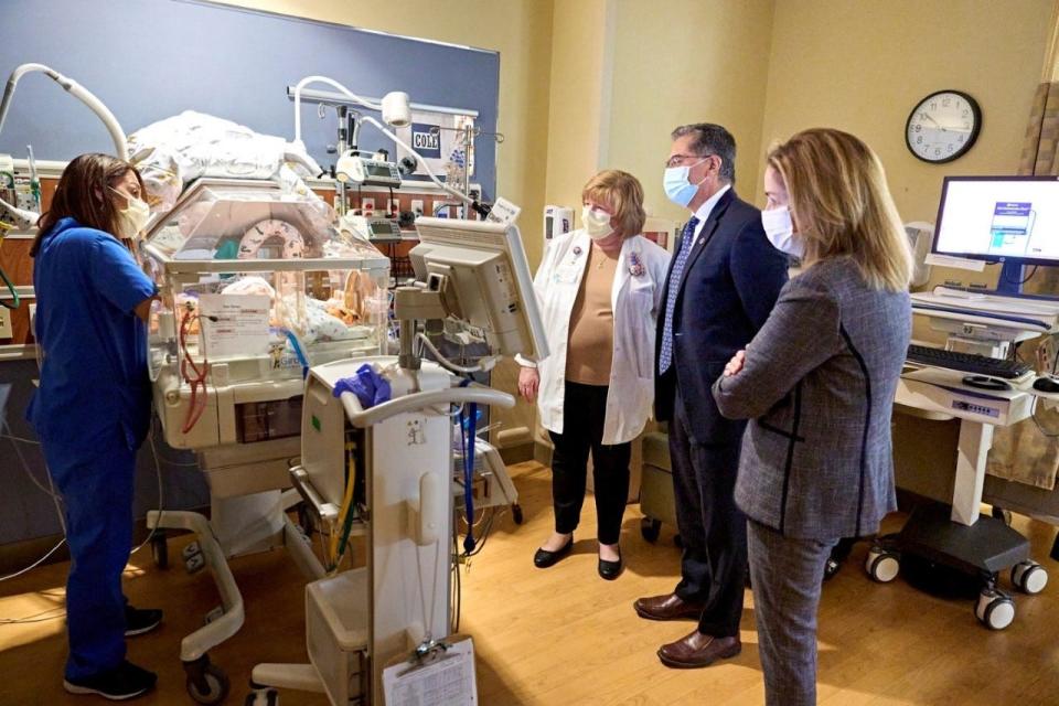 Karen Looby (second from left), Neonatal Intensive Care Unit manager at Holy Redeemer Hospital, takes U. S. Secretary of the Department of Health and Human Services Xavier Becerra and Congresswoman Madeleine Dean on a tour in the NICU as staff nurse Anita Santiago shows an incubator. About 2,800 babies are delivered at the hospital each year, including about 40 who need treatment for drug withdrawal.