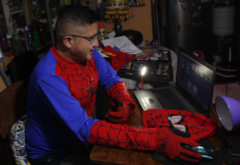 Art teacher Jorge Manolo Villarroel, wearing a Spider-Man costume, teaches an online class from his home, amid the new coronavirus pandemic in La Paz, Bolivia, Tuesday, June 9, 2020. "Education stagnated in traditional molds. After the pandemic everything will change, including education," Villarroel said. (AP Photo/Juan Karita)