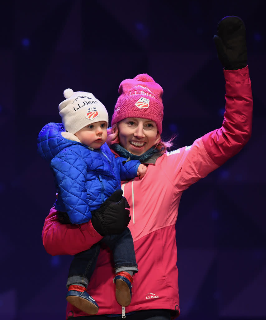 Randall holds her son Breck in one arm on the podium. (Photo: Getty Images)