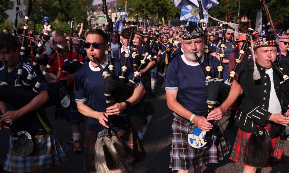 <span>Pipers lead fans to watch Scotland v Switzerland on 19 June 2024.</span><span>Photograph: Thilo Schmülgen/Reuters</span>