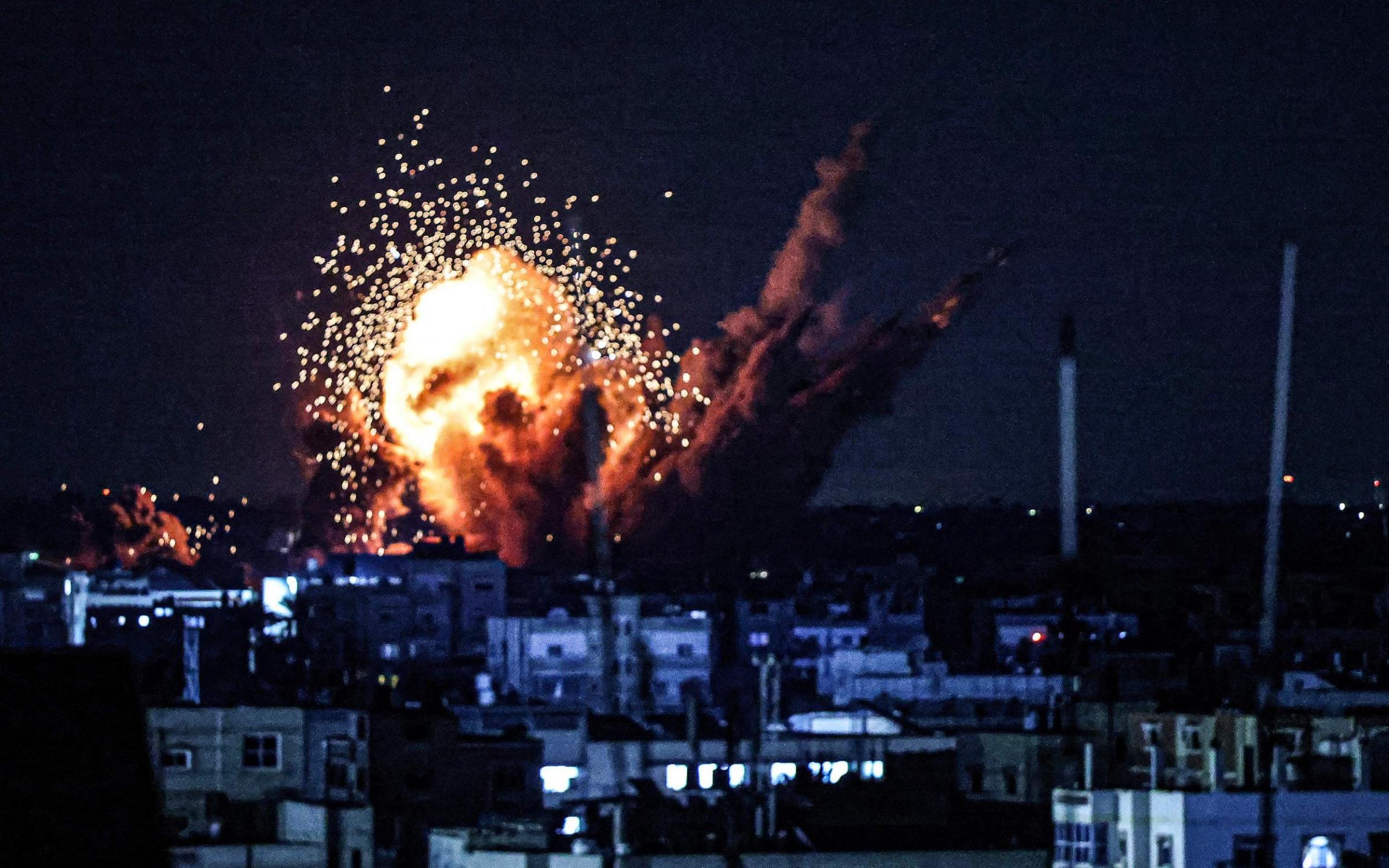 A ball of fire and smoke rise above buildings during an Israeli strike on Rafah in the southern Gaza Strip