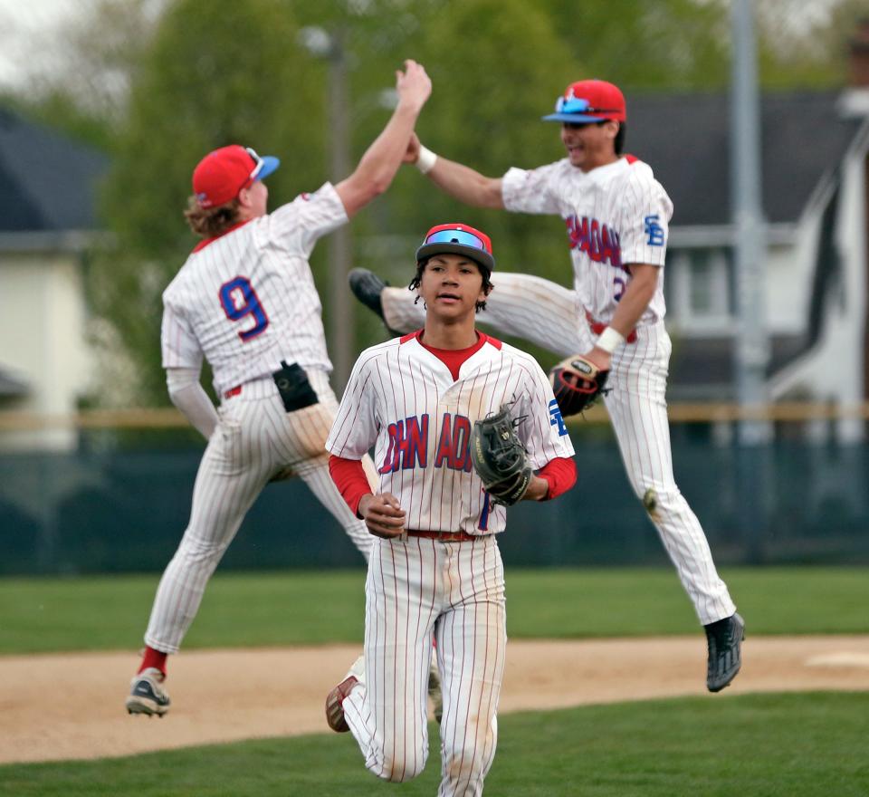 Adams senior Phil Northern runs off the field as seniors Jacob Mulvehill (9) and KJ Johnston (2) celebrate behind him following an 11-4 victory over Penn in a baseball game Monday, April 22, 2024, at School Field in South Bend.