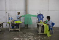 Workers from the Vila Isabel samba school make scrubs, for medical workers to wear during the new coronavirus pandemic in Rio de Janeiro, Brazil, Tuesday, April 7, 2020. Samba schools that a spend all year making Carnival costumes have turned their sewing machines to a different purpose, making scrubs and face masks for medical workers. (AP Photo/Silvia Izquierdo)