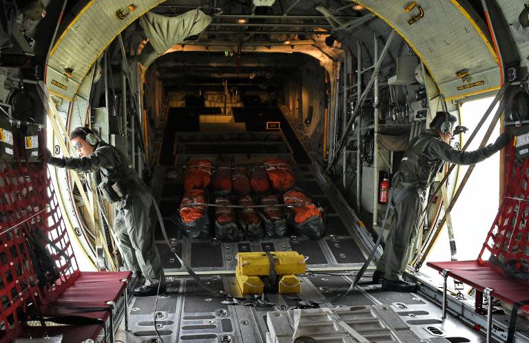 Republic of Singapore Air Force (RSAF) servicemen onboard a C-130 aircraft take part in the search and locate (SAL) operation for missing AirAsia flight QZ8501 over the Java Sea on December 30, 2014