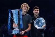 Tennis - ATP Finals - The O2, London, Britain - November 18, 2018 First placed Alexander Zverev of Germany and second placed Novak Djokovic of Serbia pose for photographs with their trophies after the final Action Images via Reuters/Andrew Couldridge