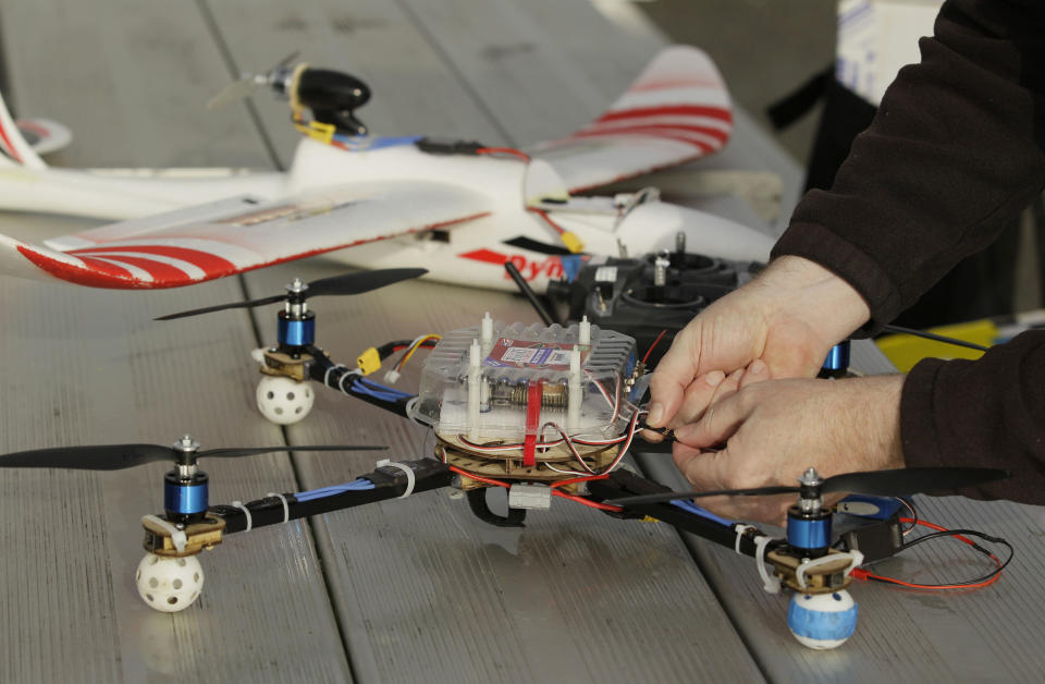 In this March, 28, 2012, photo, Mark Harrison prepares his Arcti Copter 5 drone for flight over a waterfront park in Berkeley, Calif. Interest in the domestic use of drones is surging among public agencies and private citizens alike, including a thriving subculture of amateur hobbyists, even as the prospect of countless tiny but powerful eyes circling in the skies raises serious privacy concerns. (AP Photo/Eric Risberg)