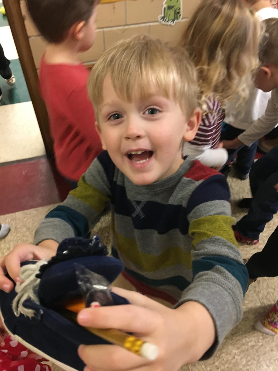 James Phillippe shows off the treats left in his shoe by St. Nicholas after he visited Immaculate Conception School in Freemont, Ohio.