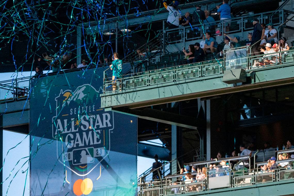 Former Mariners Mike Cameron and Bret Boone unveil the logo for the 2023 All-Star game prior to the start of Seattle’s game against the Houston Astros on Friday, July 22, 2022, at T-Mobile Park in Seattle.