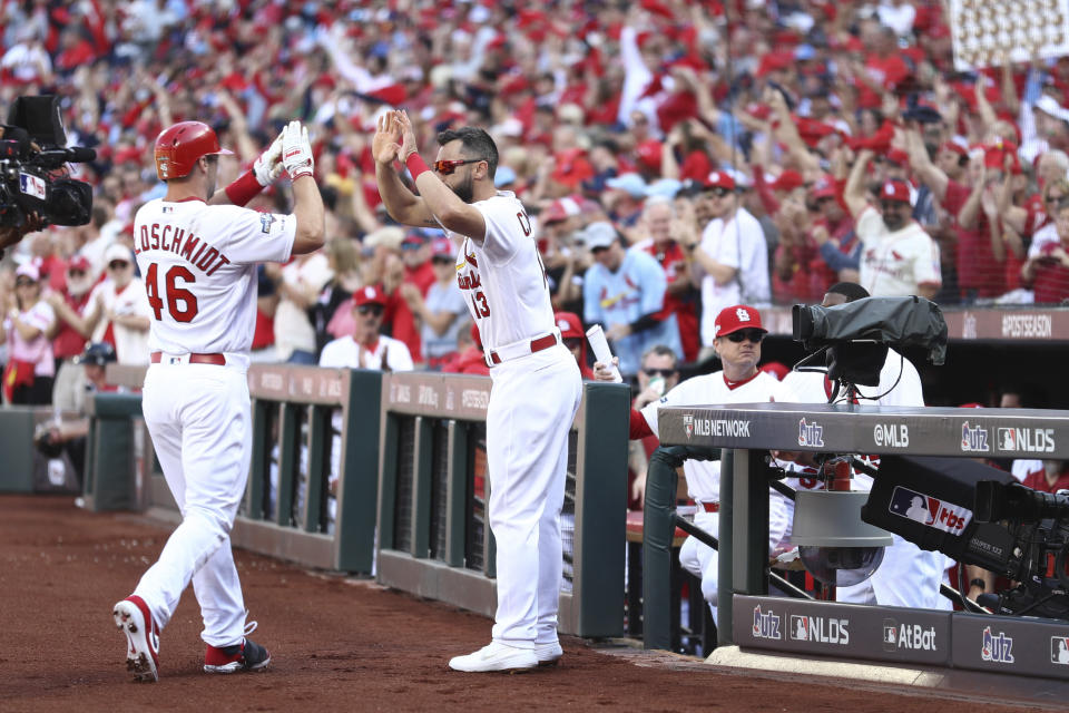 St. Louis Cardinals' Paul Goldschmidt (46) celebrates with Matt Carpenter (13) after hitting a solo home run during the first inning in Game 4 of a baseball National League Division Series against the Atlanta Braves, Monday, Oct. 7, 2019, in St. Louis. (Jamie Squire/Getty via AP, Pool)