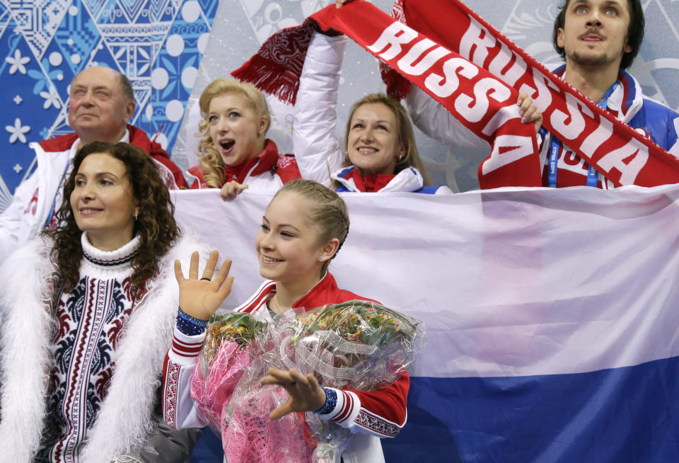 Yulia Lipnitskaya of Russia, centre, waits for her results after competing in the women's team short program figure skating competition at the Iceberg Skating Palace during the 2014 Winter Olympics, Saturday, Feb. 8, 2014, in Sochi, Russia. (AP Photo/Darron Cummings, Pool)