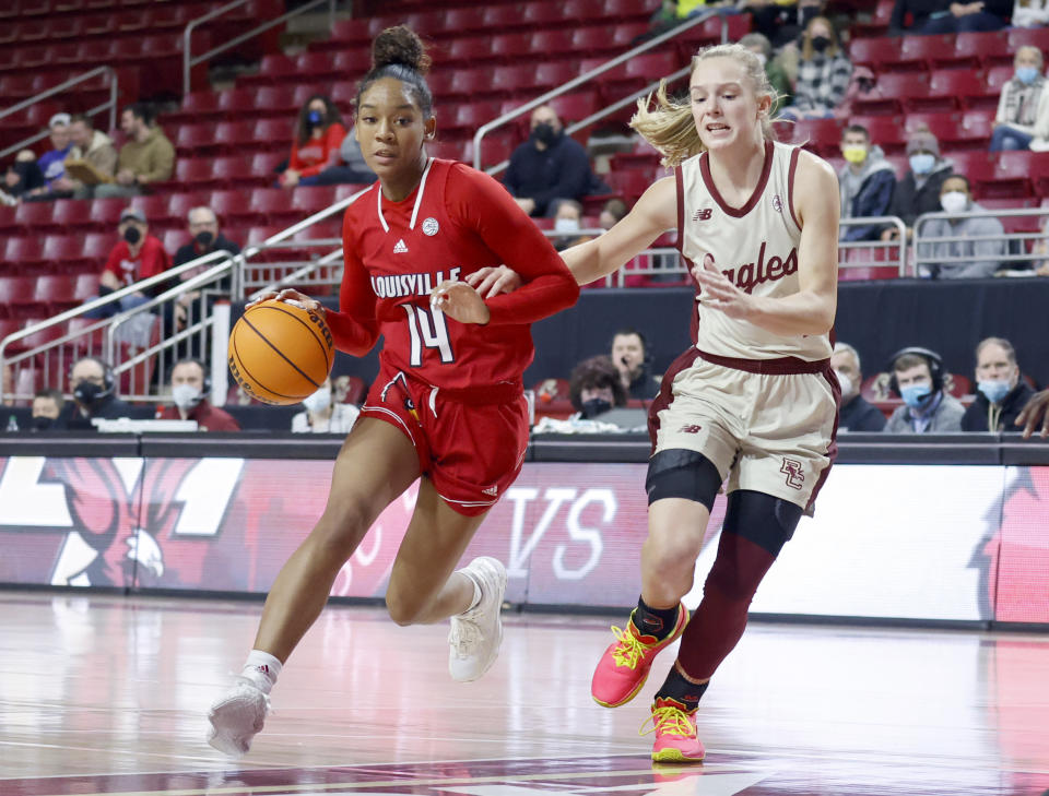 Louisville guard Kianna Smith (14) drives the ball up the court as Boston College guard Cameron Swartz (1) defends during the first half of an NCAA college basketball game, Sunday, Jan. 16, 2022, in Boston. (AP Photo/Mary Schwalm)