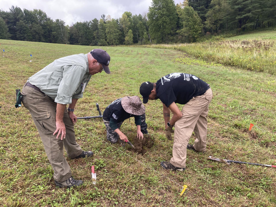 Volunteer trainer Bill Rose, left, watches veterans Katherine Kuzmick and Bjorn Bruckshaw work at an archaeological dig at the site of the Second Battle of Saratoga, Thursday, Sept. 9, 2021, in Stillwater, N.Y. Veterans with American Veterans Archaeological Recovery are searching for Revolutionary War artifacts at the Saratoga National Historical Park this month. (AP Photo/Michael Hill)