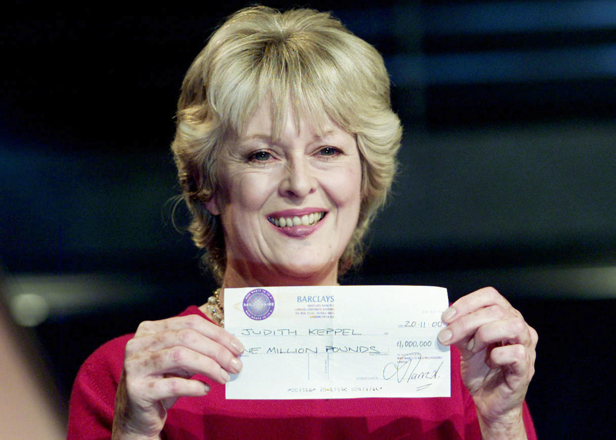British gameshow contestant Judith Keppel shows off the cheque she won on 'Who Wants To Be A Millionaire' at a photocall in Elstree studios Borehamwood, November 20, 2000. Ms Keppel, a distant cousin of Prince Charles' partner Camilla Parker Bowles, will become the first contestant to claim the one million pound (sterling) prize money when the show is broadcast on British television tonight.

KD/BR