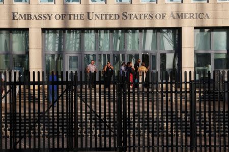 Cuban employees enter the U.S. Embassy in Havana, Cuba, August 22, 2018. REUTERS/Stringer