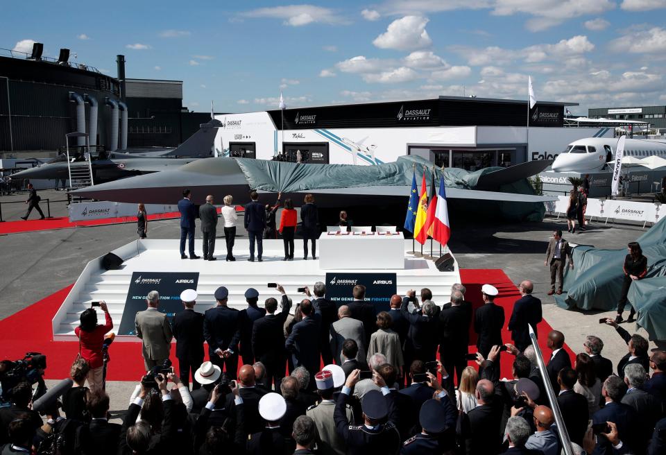 French President Emmanuel Macron, Eric Trappier, Chairman and CEO of Dassault Aviation, Spanish Defence Minister Margarita Robles, French Defence Minister Florence Parly, and German Defense Minister Ursula von der Leyen attend the unveiling of the full-scale jet fighter model of the NGF, during the Paris Air Show on June 17, 2019. <em>YOAN VALAT/AFP via Getty Images</em>