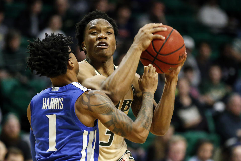 UAB guard Tavin Lovan (3) drives to the basket as Memphis guard Tyler Harris (1) defends during the second half of an NCAA college basketball game Saturday, Dec. 7, 2019, in Birmingham, Ala. (AP Photo/Butch Dill)