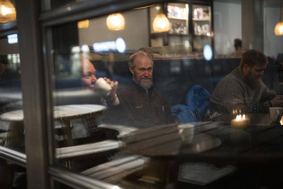 Retired miners gather together at a coffee shop in Longyearbyen, Norway, Wednesday, Jan. 11, 2023. (AP Photo/Daniel Cole)