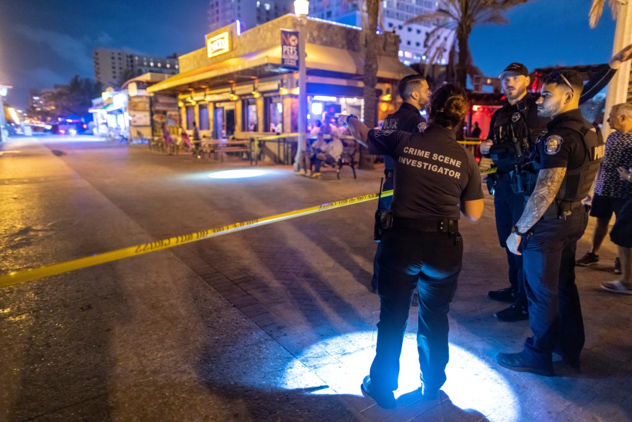 Police officers search the area where gunfire broke out along a beach boardwalk in Hollywood, Florida, USA, 29 May 2023 (EPA)