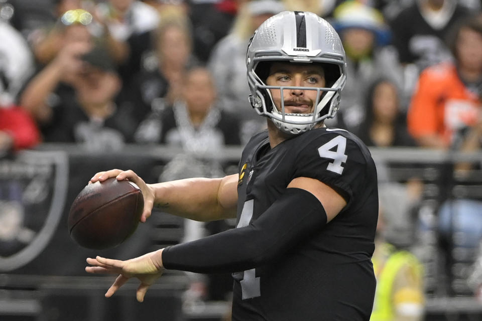 Las Vegas Raiders quarterback Derek Carr (4) looks to pass against the Denver Broncos during the first half of an NFL football game, Sunday, Dec. 26, 2021, in Las Vegas. (AP Photo/David Becker)