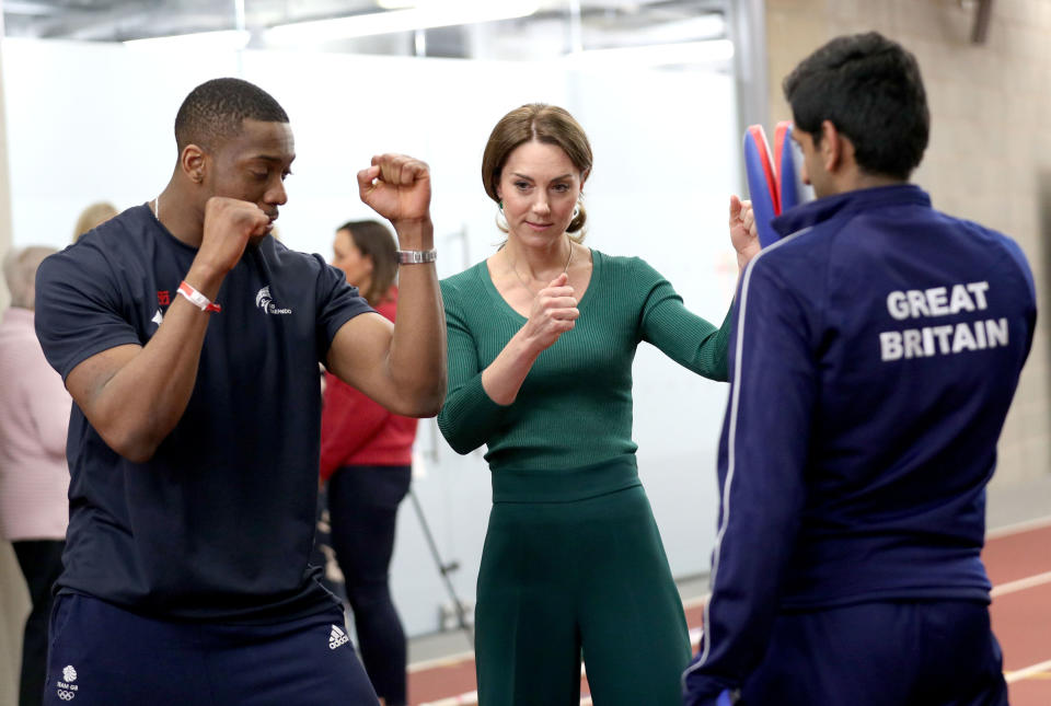 Britain's Catherine, Duchess of Cambridge (C), is shown Taekwondo moves by Britain's Lutalo Muhammad (L) during a SportsAid event at the London Stadium in east London on February 26, 2020. (Photo by Yui Mok / POOL / AFP) (Photo by YUI MOK/POOL/AFP via Getty Images)