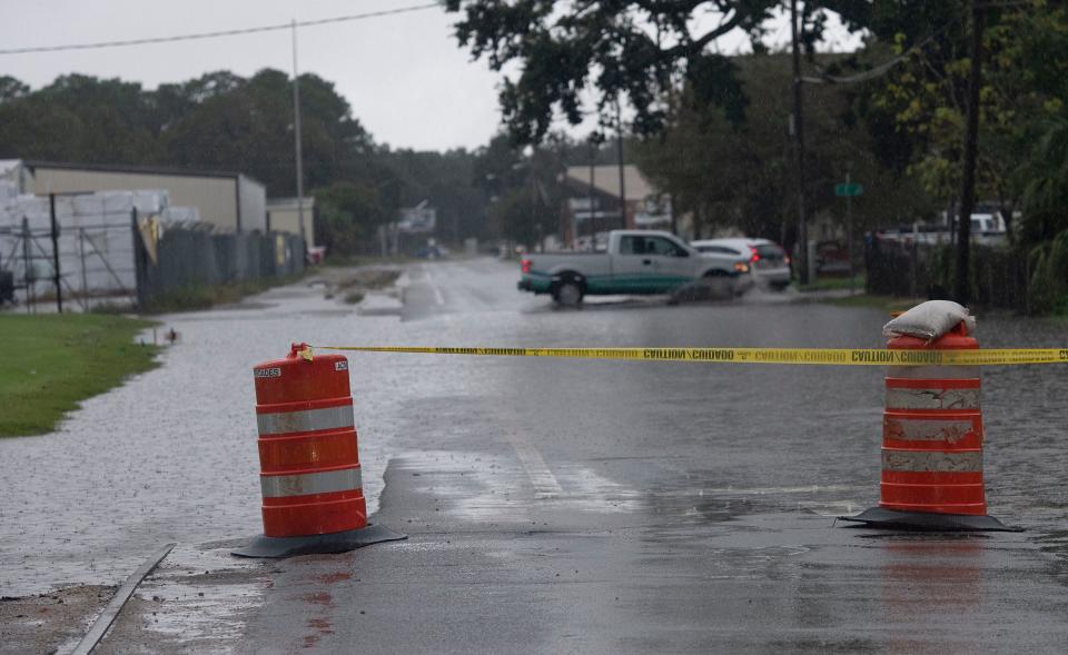 Heavy rain causes street flooding along Main Street in downtown Pensacola on Oct. 4.